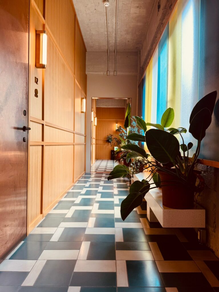 A corridor at K5 in Tokyo, where large plants stand in for internal walls