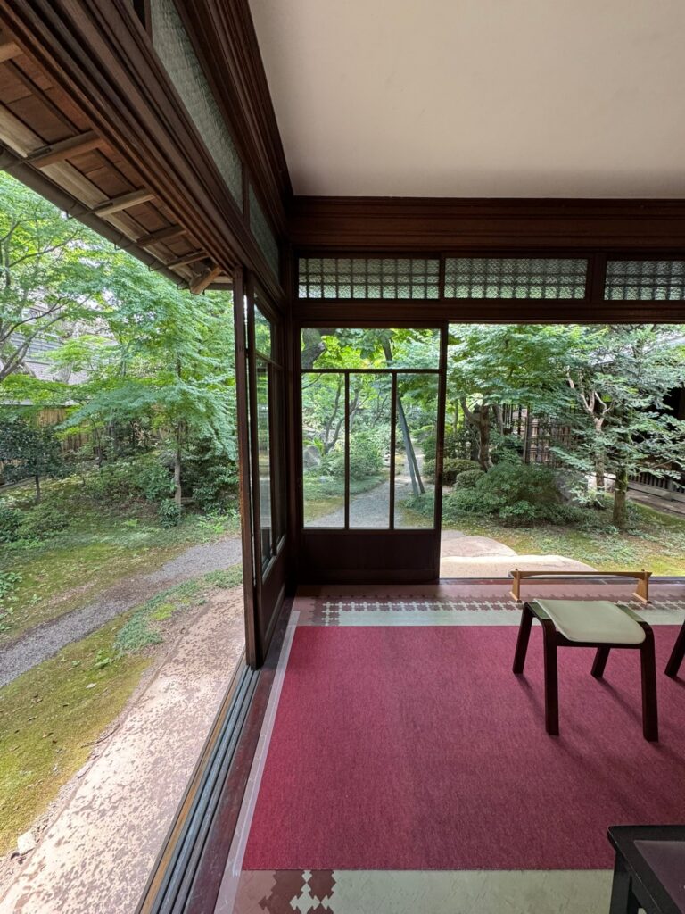 The glazed veranda of a hundred-year-old house in Yanaka, Tokyo, with a crimson carpet