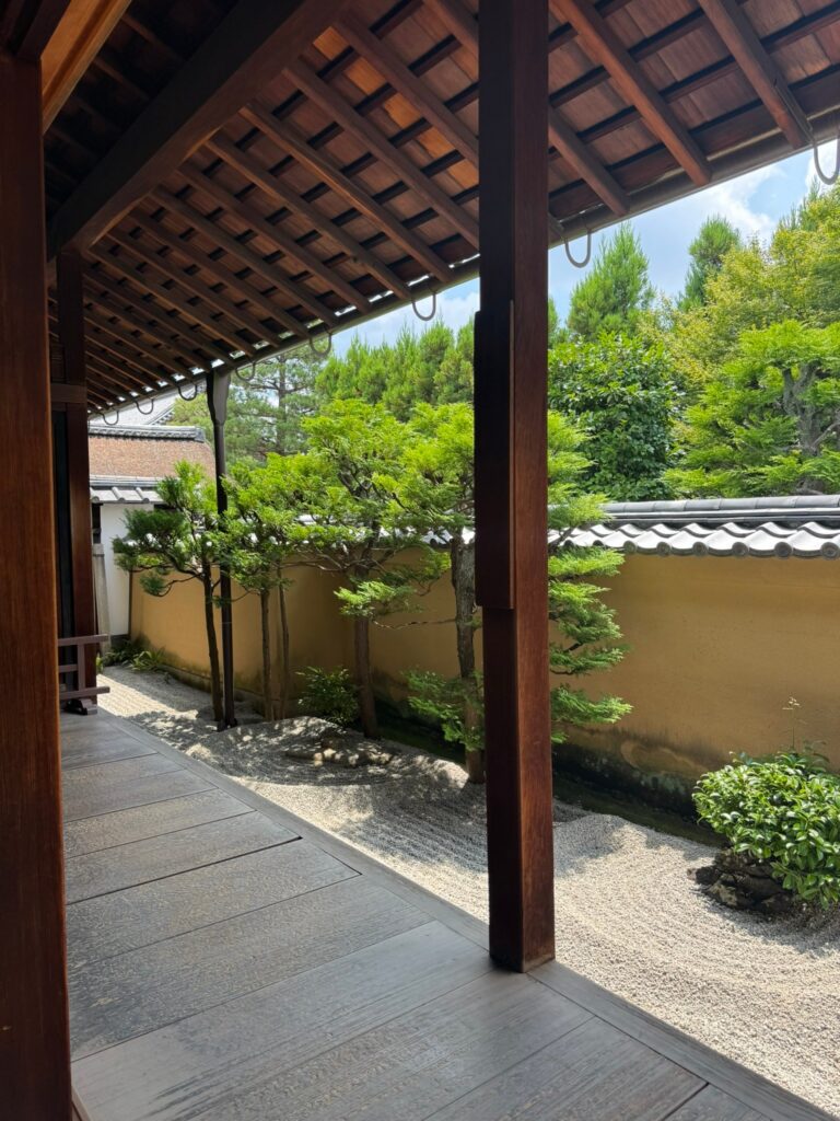 A covered timber veranda looking onto a garden of raked gravel